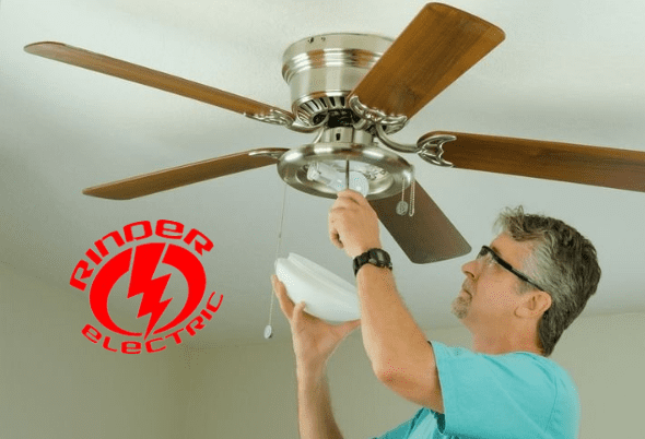 A man is fixing the ceiling fan of his home.